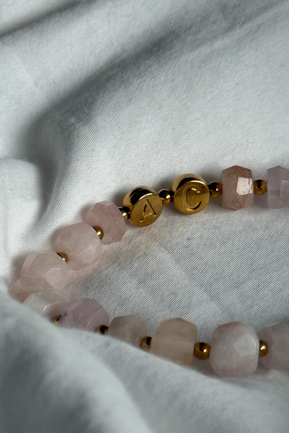 Rosa Edelsteinarmband mit goldenen Buchstaben zur Personalisierung